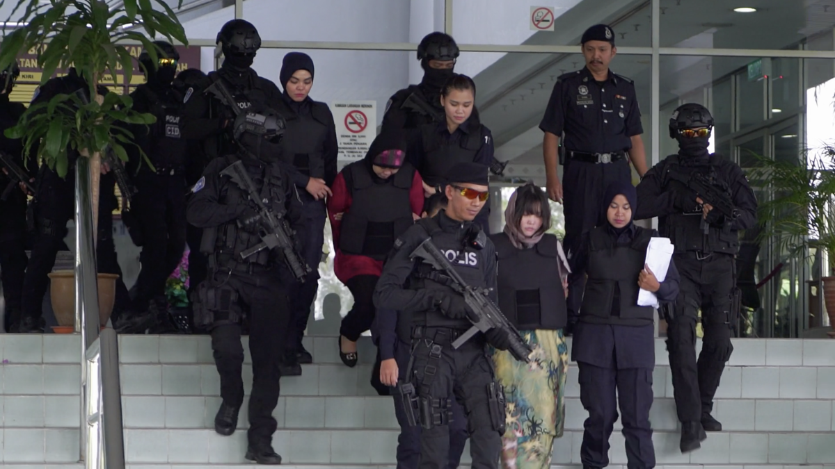 Doan Thi Huong and Siti Aisyah are escorted out of the courthouse by armed guards in the documentary "Assassins."