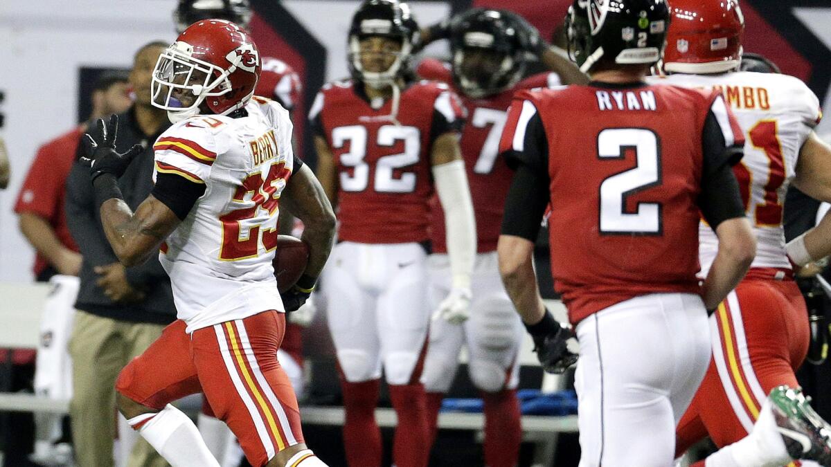 Chiefs safety Eric Berry (29) returns an interception for a score against the Falcons on Sunday.