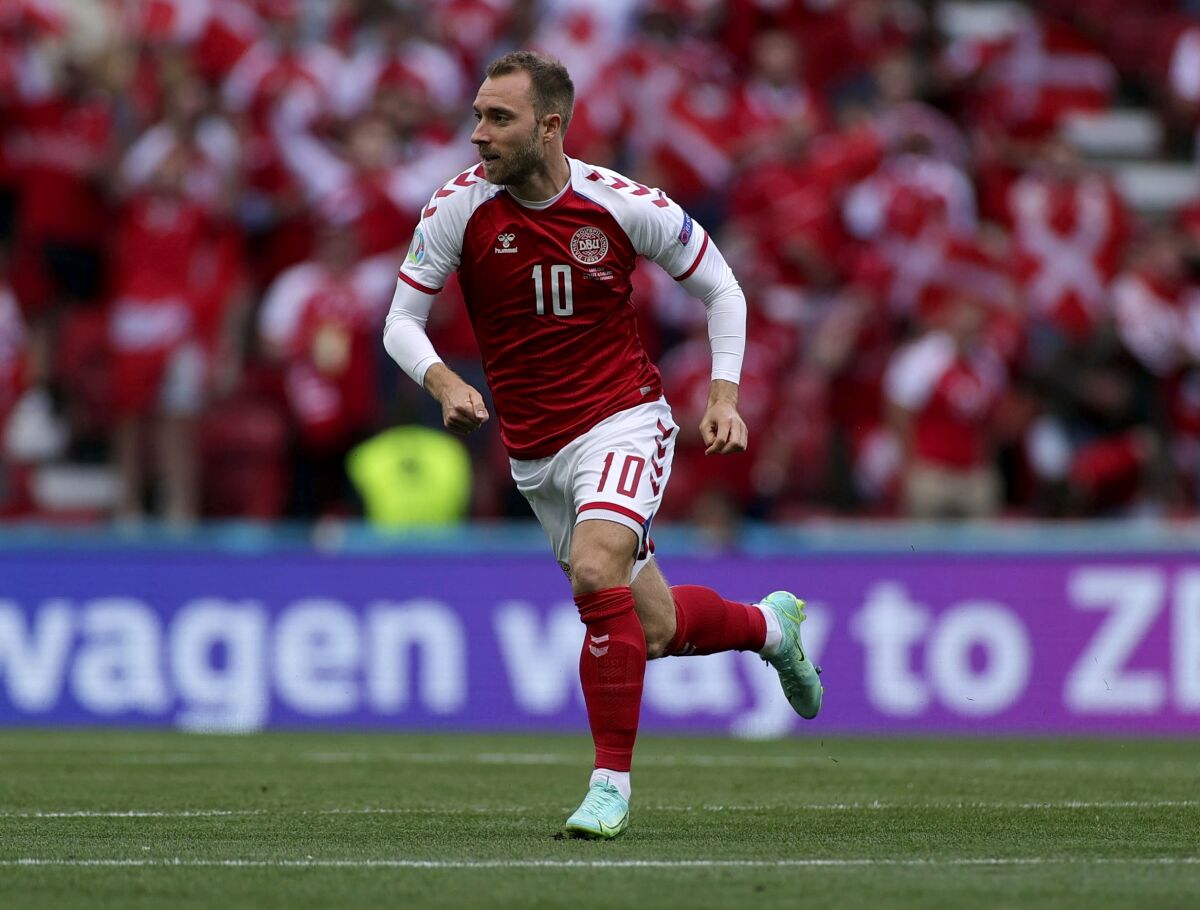 FILE - Denmark's Christian Eriksen runs during the Euro 2020 soccer championship group B match between Denmark and Finland at Parken stadium in Copenhagen, Denmark, Saturday, June 12, 2021. Eriksen is targeting a comeback from his cardiac arrest to play for Denmark in the World Cup in November. The 29-year-old Eriksen has not played since collapsing during Denmark’s opening match at the European Championship against Finland in June. (Wolfgang Rattay/Pool via AP, File)
