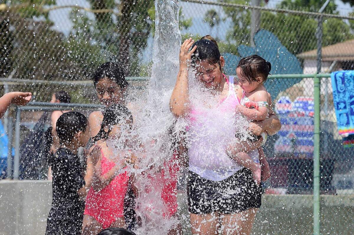 Children cool off at a water park on a hot summer day in Alhambra.