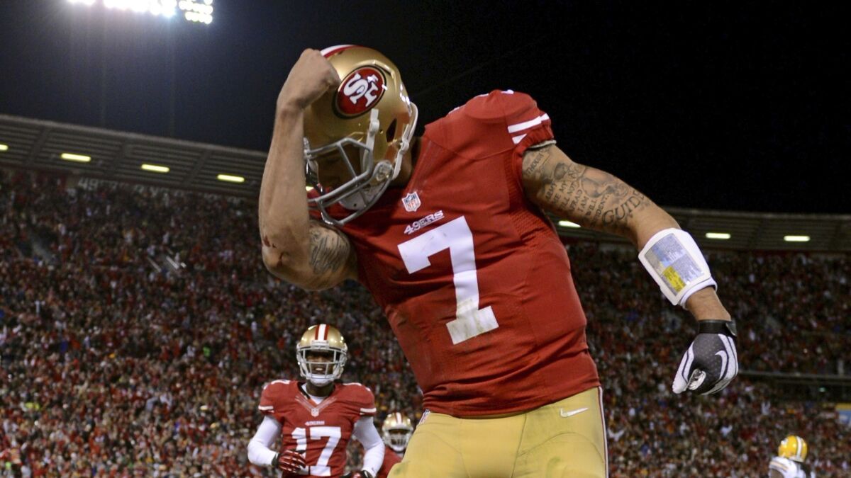 Colin Kaepernick celebrates after running in a touchdown in the first quarter against the Green Bay Packers during the NFC Divisional Playoff Game at Candlestick Park on January 12, 2013 in San Francisco.