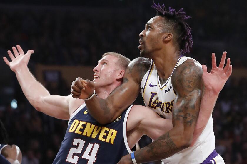 LOS ANGELES, CALIF. - DEC. 22, 2019. Lakers center Dwight Howard fights for position under the basket against Nuggets center Mason Plumlee in the second quarter Sunday night, Dec. 22, 2019, at Staples Center in Los Angeles (Luis Sinco/Los Angeles Times)