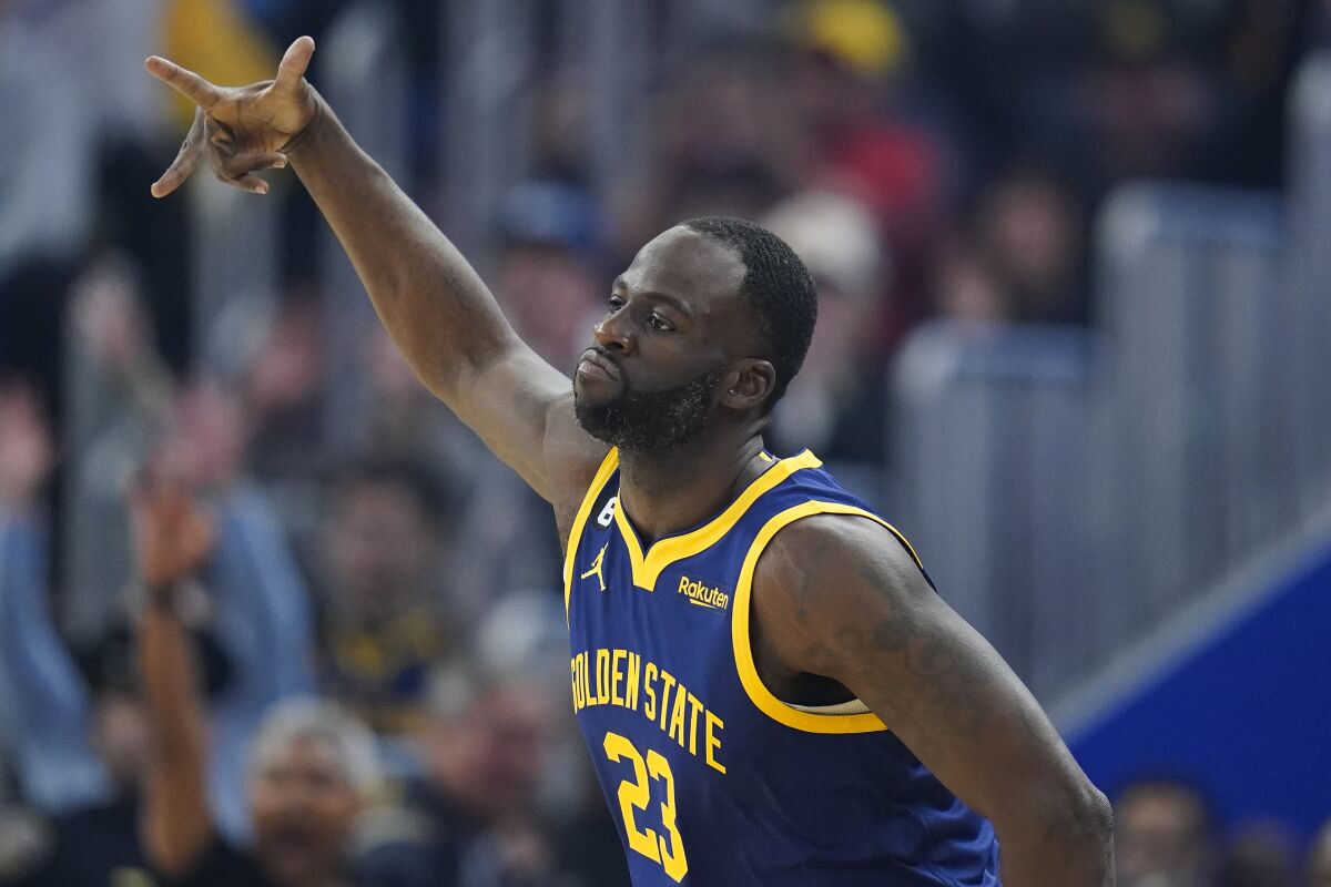 Golden State Warriors forward Draymond Green celebrates after scoring a 3-point basket against the Houston Rockets during the first half of an NBA basketball game in San Francisco, Saturday, Dec. 3, 2022. (AP Photo/Godofredo A. Vásquez)