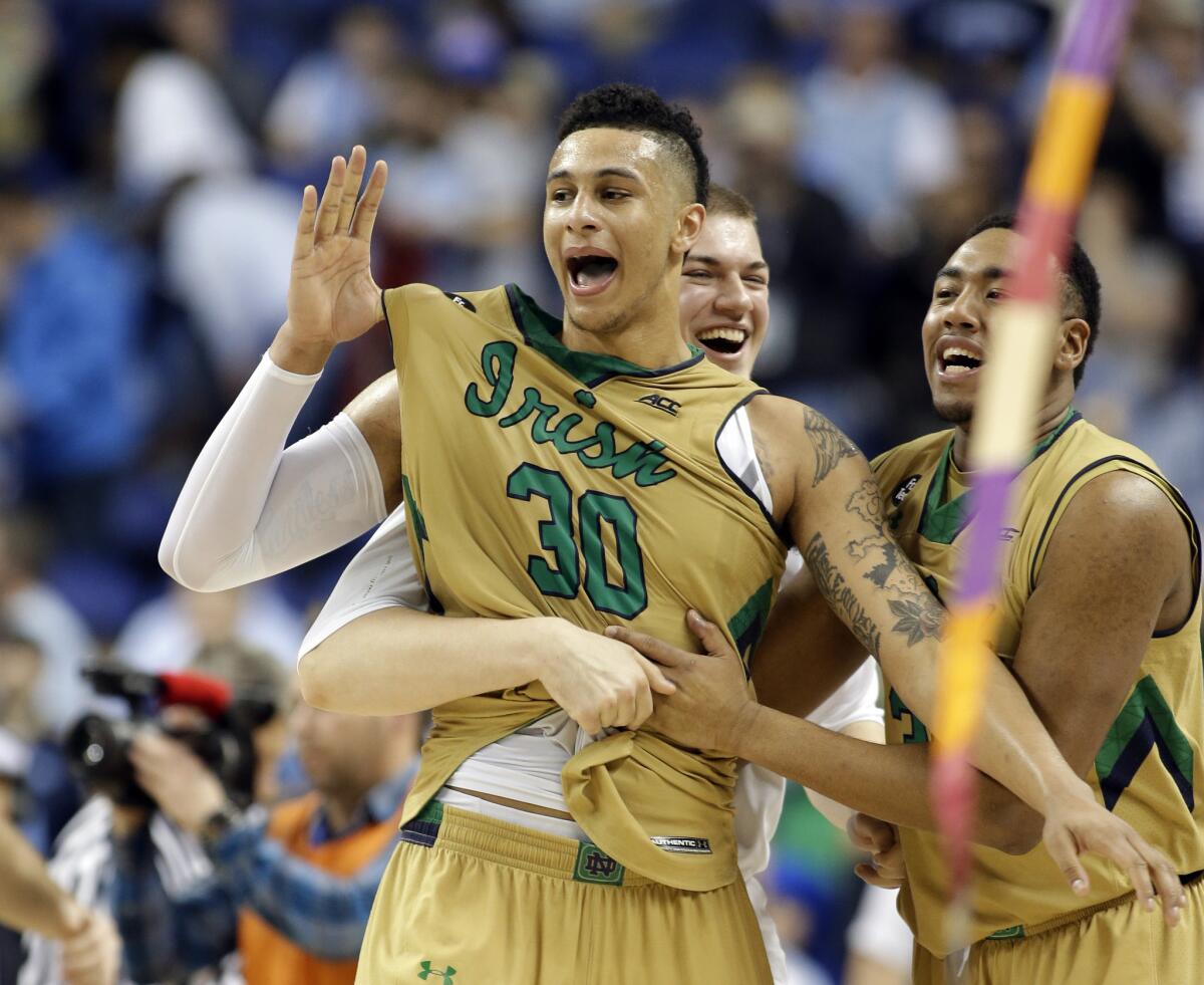 Zach Auguste (30) celebrates with his Notre Dame teammates after beating North Carolina in the ACC tournament championship game Saturday night.