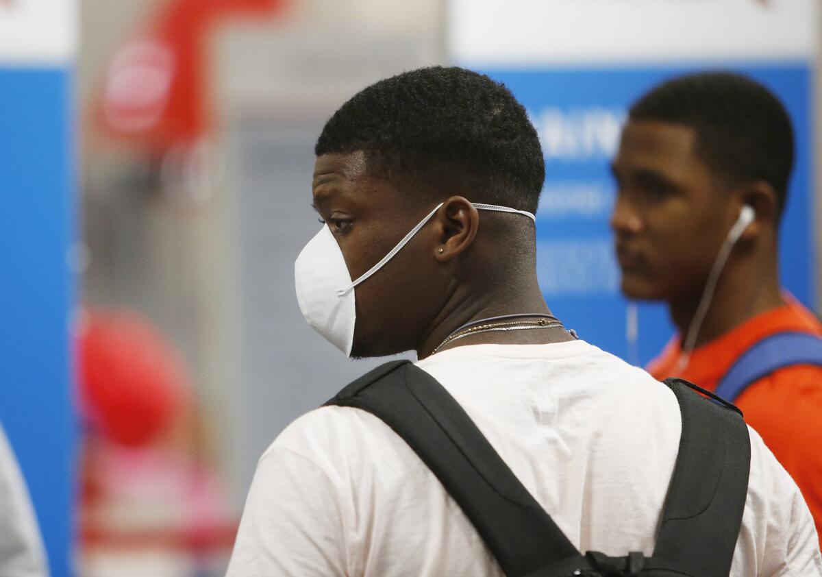 Blue Jays minor leaguer Luis De Los Santos wearing a face mask at Tampa International Airport.