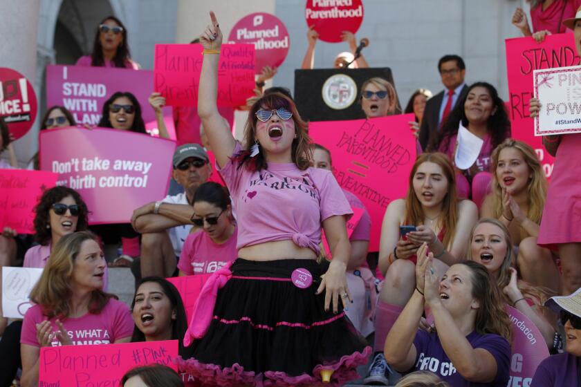 Sarah Weismer of Long Beach stands and chants along with Planned Parenthood supporters, staff and volunteers rallying on the Los Angeles City Hall steps to speak out for women's access to reproductive healthcare on National Pink Out Day.