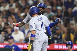 Los Angeles Dodgers' Miguel Rojas (11) celebrates with Jason Heyward after hitting a two-run home run.