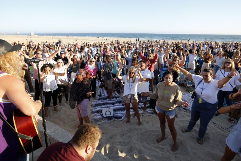 Hundreds gathered for the weekly Saturate OC worship event held north of the pier in Huntington Beach, on Friday, July 10, 2020.