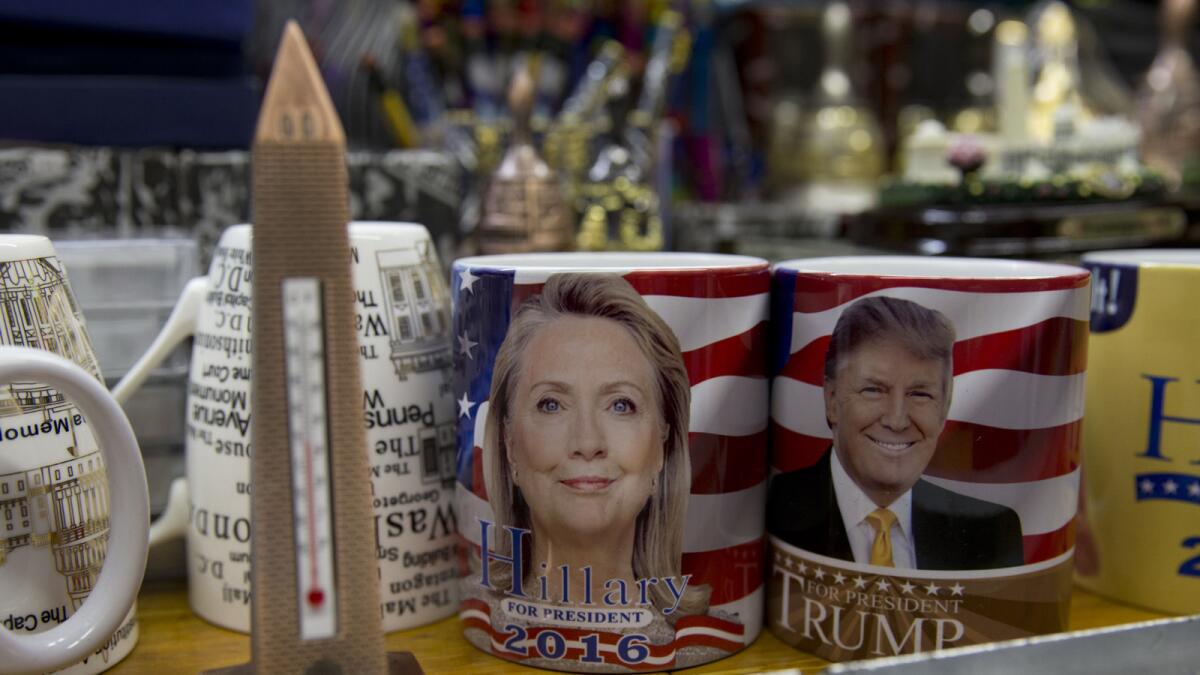 Coffee mugs for sale with the images of Democratic presidential candidate Hillary Clinton and Republican presidential candidate Donald Trump sit side by side on a shelf of a souvenir s