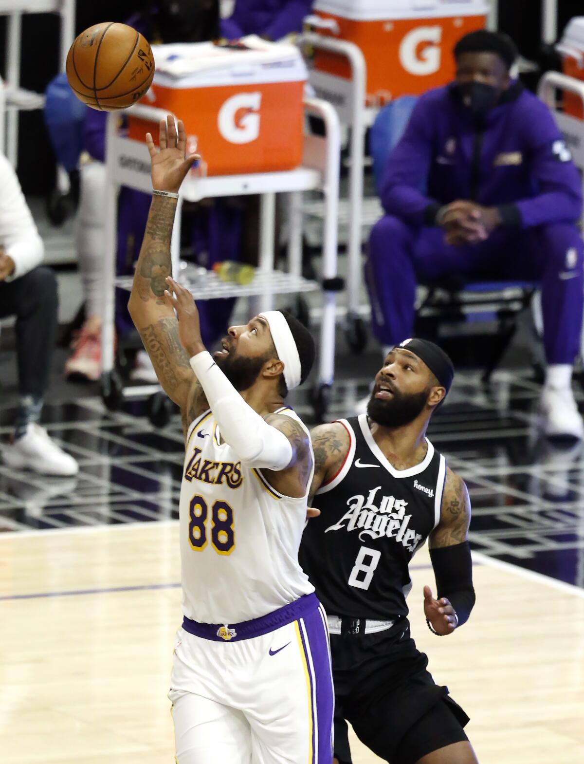 Lakers forward Markieff Morris receives a pass in front of twin brother and Clippers forward Marcus Morris Sr. 