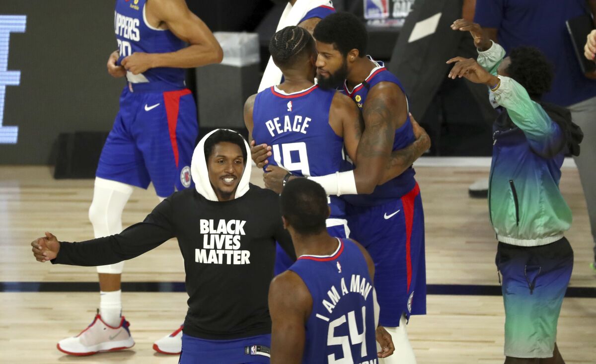 Clippers players celebrate a win over the Portland Trail Blazers on Aug. 8, 2020.