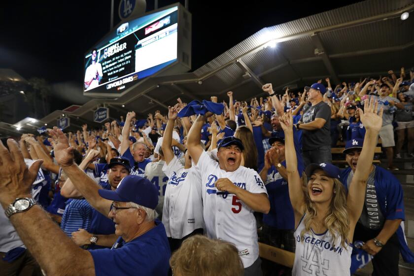 Dodger fans cheer in the left field pavilion as Corey Seager hits a two-run homer in the sixth for a 3-1 Dodgers lead in Game 2 of the 2017 World Series at Dodger Stadium.