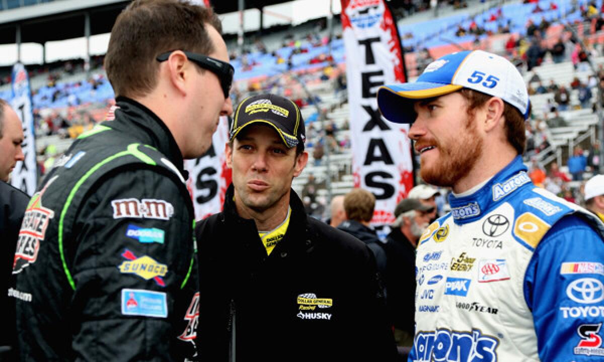 NASCAR Sprint Cup Series drivers Kyle Busch, left, Matt Kenseth and Brian Vickers chat on pit road before the now-delayed start of Sunday's race at Texas Motor Speedway.