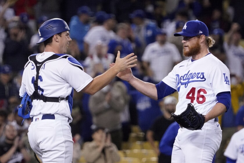 On the left, Will Smith and Craig Kimbrel celebrate 3 May 2022 after the Dodgers defeated the San Francisco Giants 3-1.