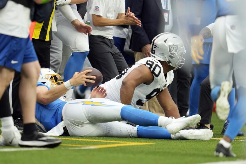 Las Vegas Raiders defensive tackle Jerry Tillery, right, hits Los Angeles Chargers quarterback Justin Herbert late as Herbert ran out of bounce during the first half of an NFL football game Sunday, Oct. 1, 2023, in Inglewood, Calif. (AP Photo/Ashley Landis)