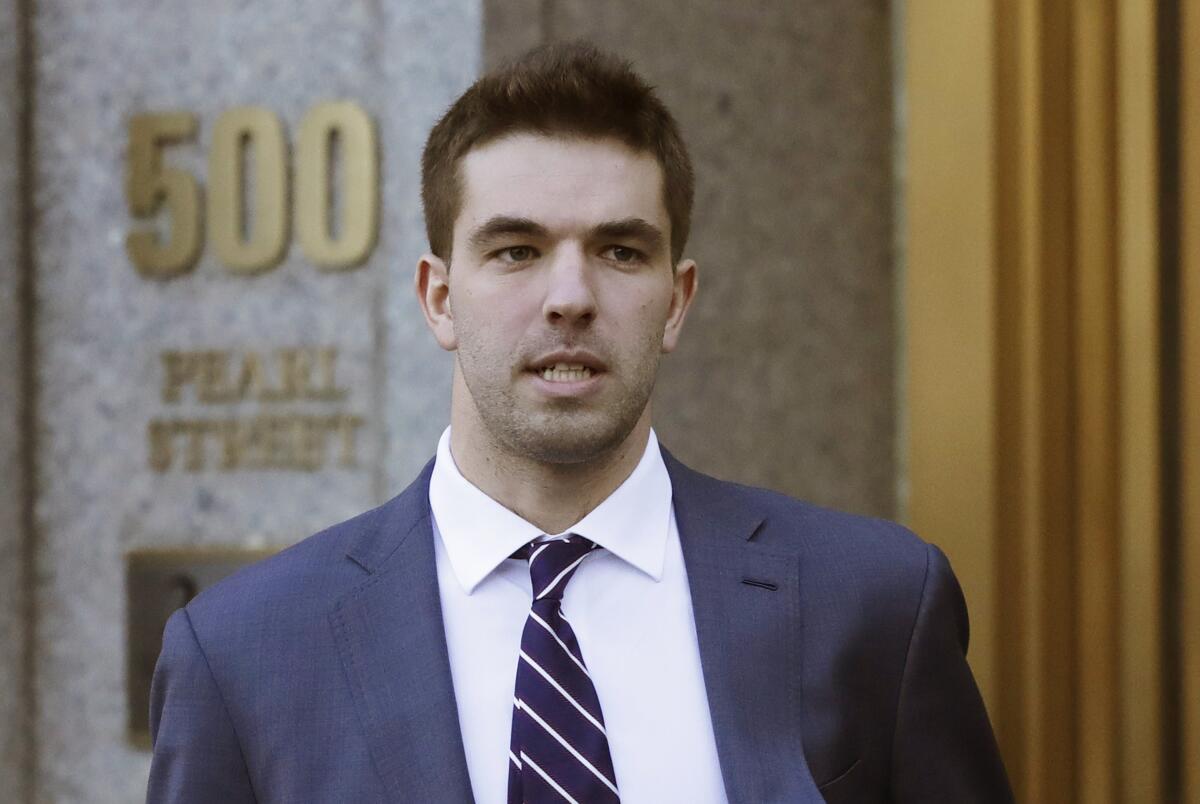 A man in a suit in front of a building that reads 500 Pearl Street