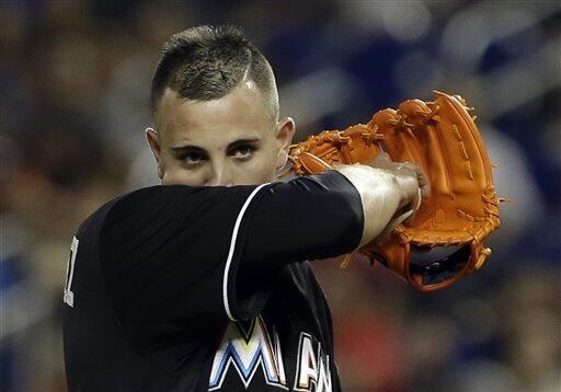 Miami Marlins' Jose Fernandez wipes his face in the first inning of a baseball game against the St. Louis Cardinals, Friday, June 14, 2013, in Miami. (AP Photo/Alan Diaz)