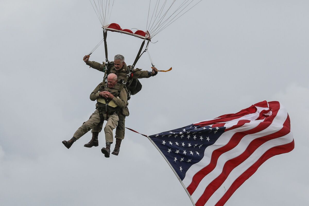 WW II vet Tom Rice (bottom) took part in a parachute drop over Carentan, Normandy, as part of D-Day's 75th anniversary.