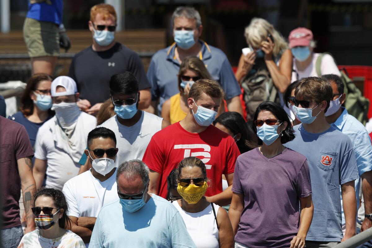 Masked passengers board a ferry bound for Peaks Island in Portland, Maine.