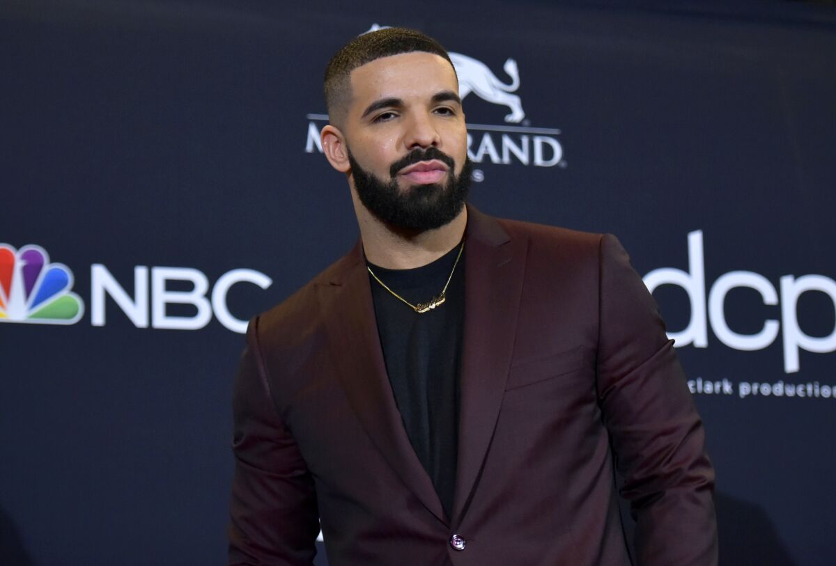 Rapper Drake in a burgundy suit jacket