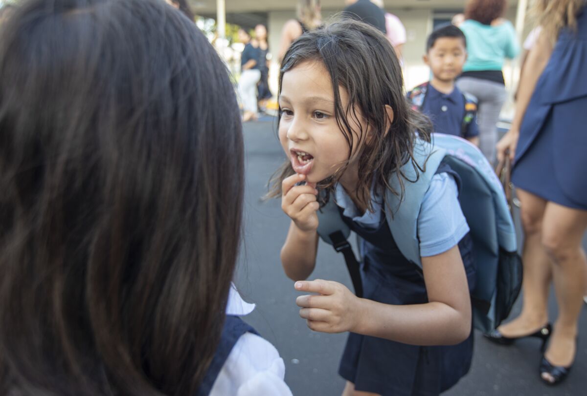 A student and her friend during the first day of school at the International School for Science and Culture in Costa Mesa. 