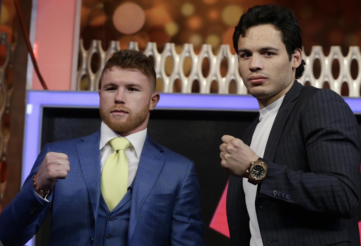 Mexican boxers Saul "Canelo" Alvarez, left, and Julio Cesar Chavez Jr., are presented during a press conference in Mexico City, Monday, Feb. 20, 2017. Alvarez and Chavez were face-to-face for the first time Monday, the first stop on a promotional tour of their May 6th Las Vegas showdown. (AP Photo/Marco Ugarte)