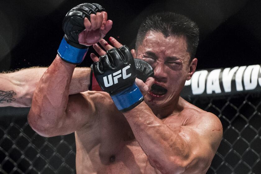 Cung Le is punched during his UFC middleweight loss to Michael Bisping in Macao on Aug. 23.