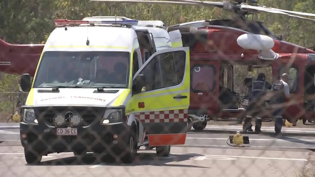 An ambulance is backed up to a helicopter in Darwin, Australia.