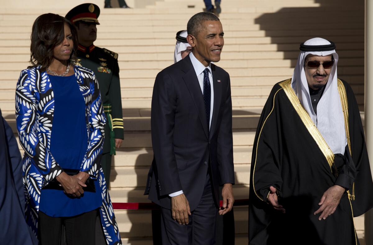 President Obama and First Lady Michelle Obama, her head uncovered, stand with new Saudi King Salman during official greetings at the airport in Riyadh, the Saudi Arabian capital, on Tuesday.