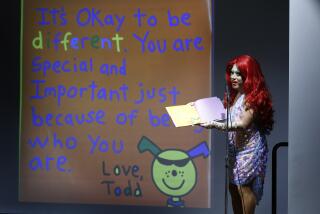 Raquelita, a drag queen, reads the book It's Okay To Be Different during Drag Queen Story Time at the Chula Vista Civic Center Library on Sept. 10, 2019.