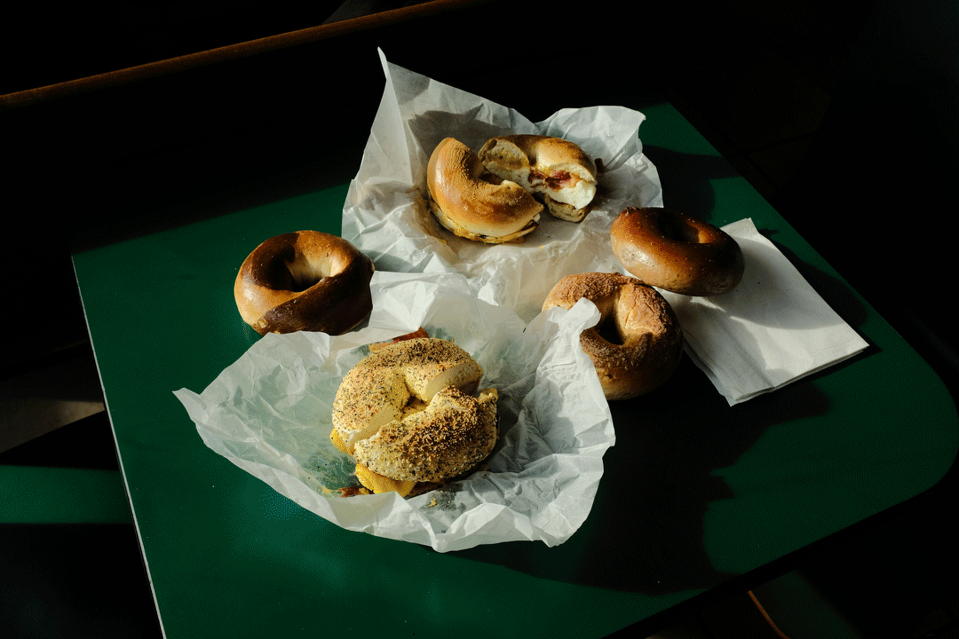Flashing images of the inside and outside of Bagel Broker, and bagels on waxed paper.
