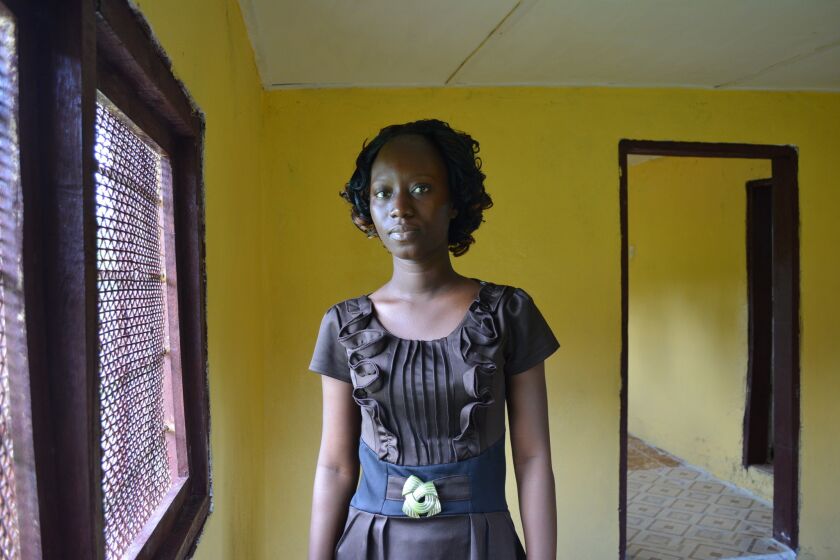 Liberian student nurse Fatu Kekula, shown on Oct. 5, saved her father's life in this makeshift isolation ward in a spare, unfinished room at home, using nothing more than raincoats and boots, plastic bags, gloves and masks.