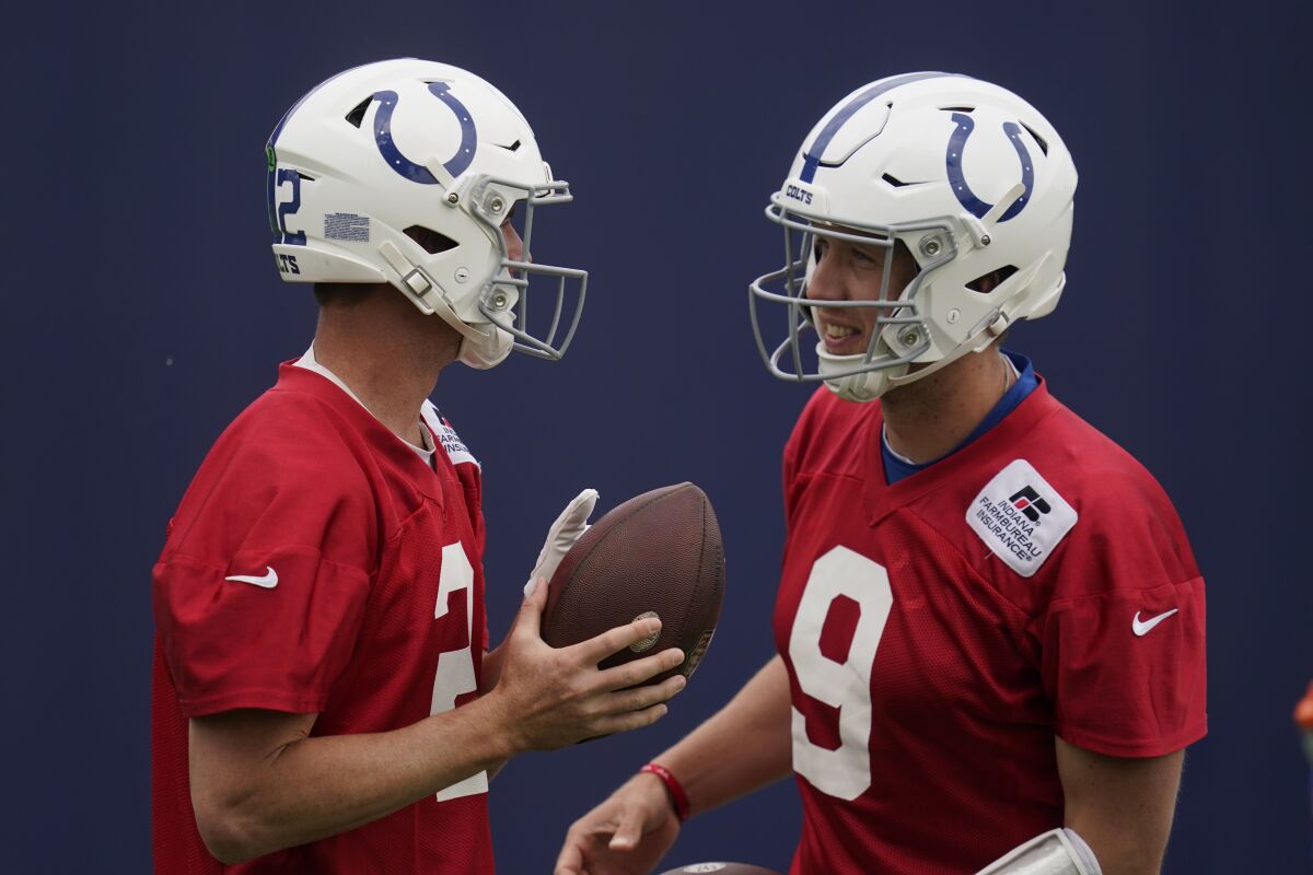 Indianapolis Colts quarterback Matt Ryan, left, talks with quarterback Nick Foles during a practice at the NFL football team's training facility, Wednesday, June 8, 2022, in Indianapolis. (AP Photo/Darron Cummings)
