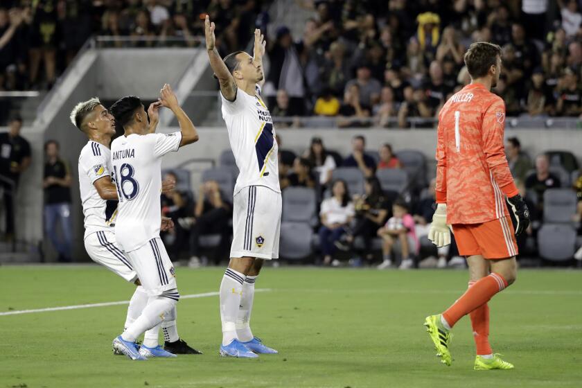 Los Angeles Galaxy's Zlatan Ibrahimovic, center, celebrates with teammates after scoring against Los Angeles FC during the first half of an MLS soccer match Sunday, Aug. 25, 2019, in Los Angeles. (AP Photo/Marcio Jose Sanchez)