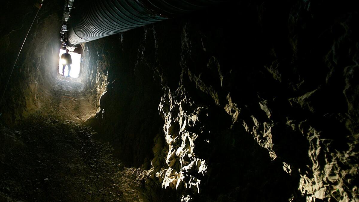 A mining executive steps into one of two tunnels dug by treasure hunters in the mining community of Kokoweef.