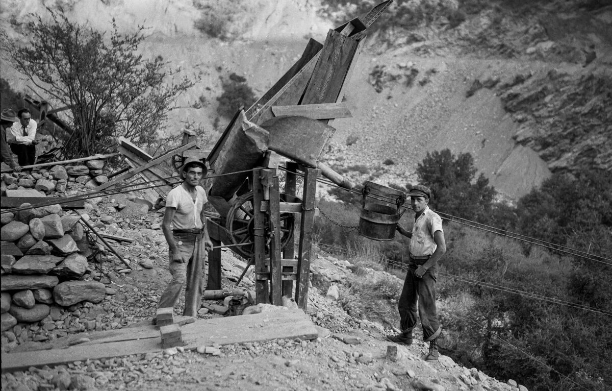 September 1932: M.L. Sims and Archie Clark send loads of gold-laden dirt down from their diggings to the East Fork of the San Gabriel River for washing. 