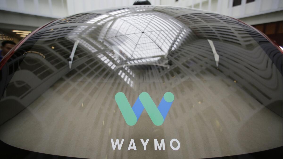 The rear window of a Waymo driverless car in San Francisco is shown.