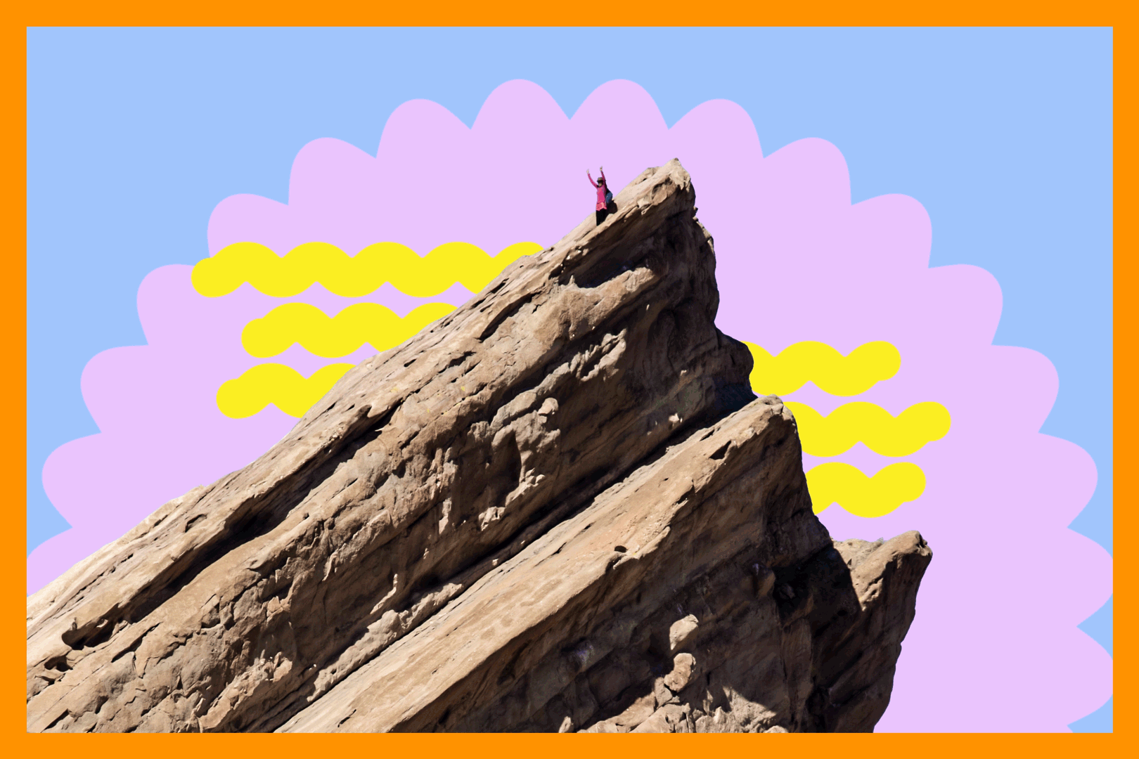 A hiker stands with hands raised at the top of a very pointy rock.