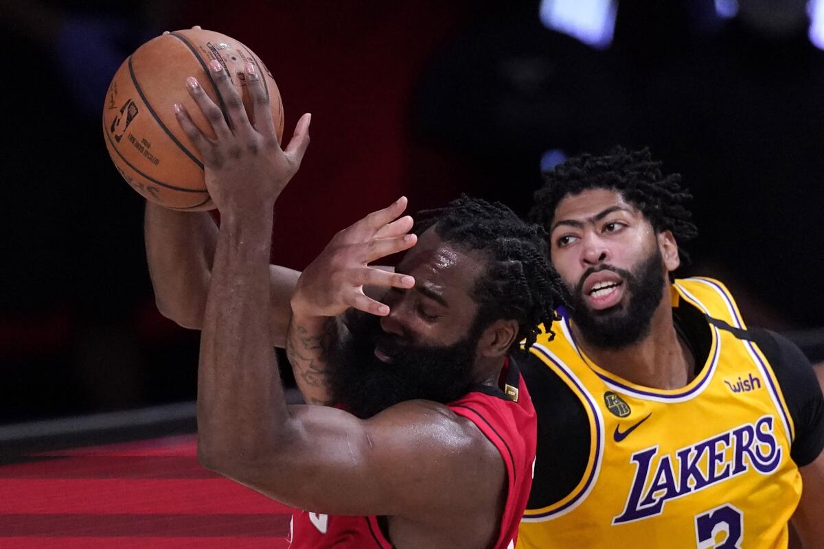 Lakers forward Anthony Davis defends against Houston Rockets guard James Harden.