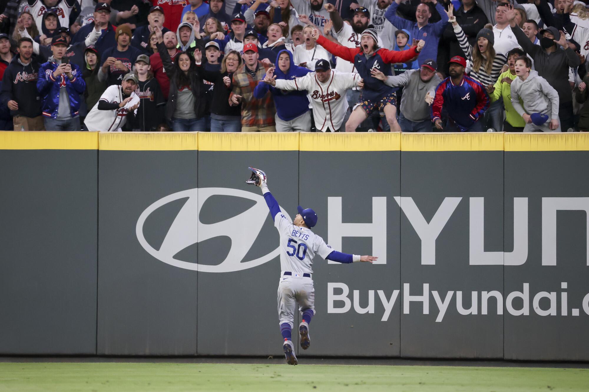 The crowd screams as Los Angeles Dodgers right fielder Mookie Betts is unable to make a play