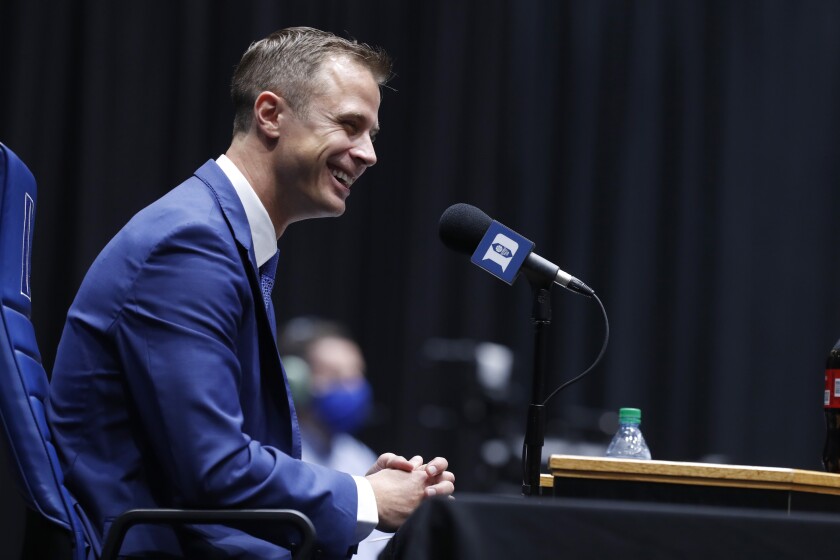 Jon Scheyer laughs during an NCAA college basketball press conference at Cameron Indoor Stadium in Durham, N.C., Friday, June 4, 2021. Scheyer will spend the upcoming year in his role as associate head coach as coach Mike Krzyzewski chases one more championship in a Hall of Fame career. Then it’s up to the 33-year-old Scheyer to take over ahead of the 2022-23 season in the program’s first coaching change in more than four decades. (Ethan Hyman/The News & Observer via AP)