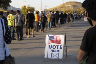 FILE - In this Nov. 3, 2020, file photo, mostly masked northern Nevadans wait to vote in-person at Reed High School in Sparks, Nev., prior to polls closing. U.S. officials say they found no evidence that foreign actors changed votes or otherwise disrupted the voting process in last November’s presidential election. That's according to government reports on March 16, 2021, affirming the integrity of the contest won by President Joe Biden. (AP Photo/Scott Sonner, File)