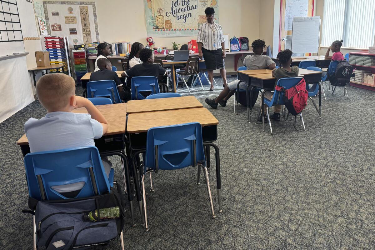 Mannika Hopkins talks with her fourth-graders on the first day of school at Greenville Elementary in Greenville, Fla.