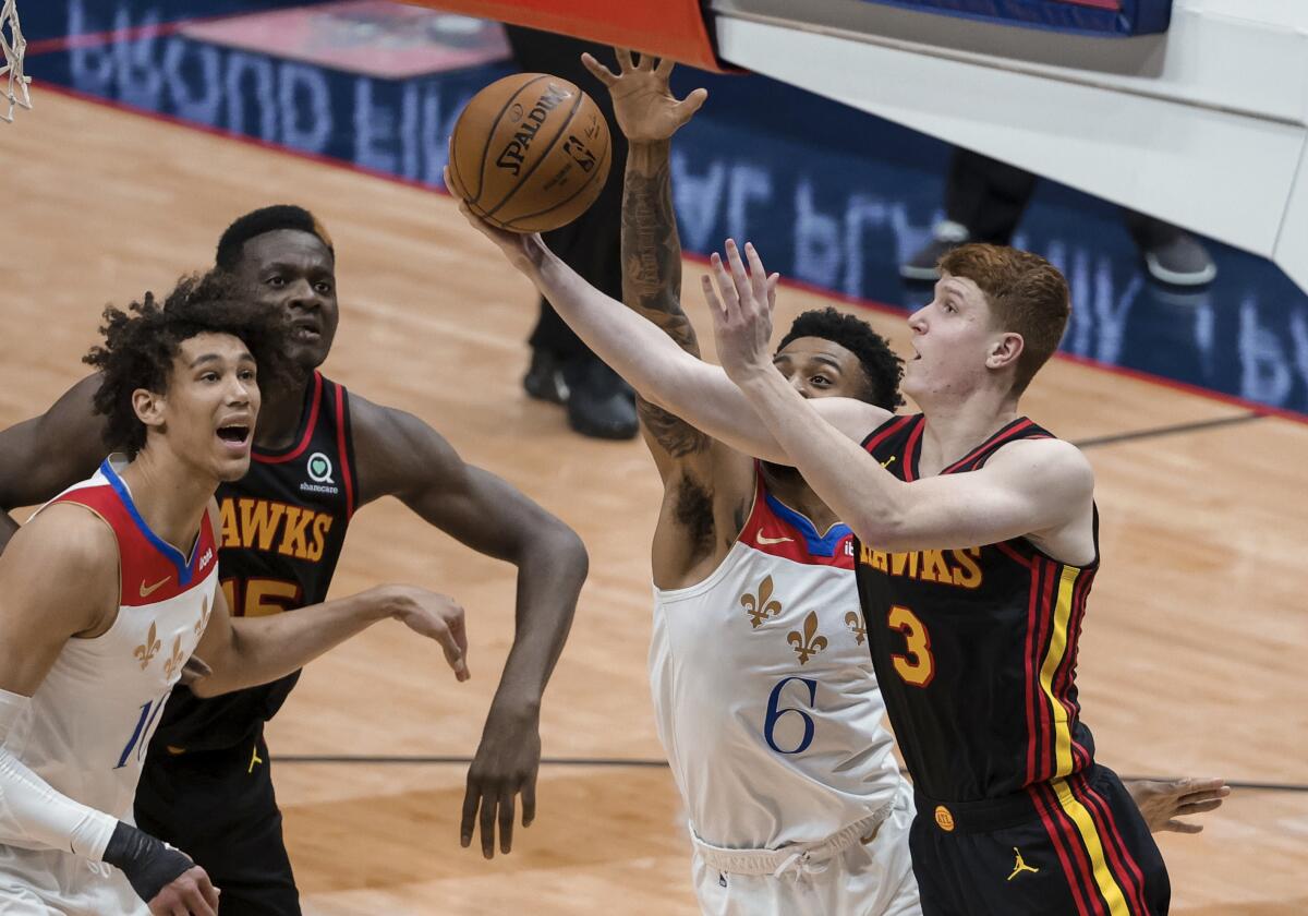 New Orleans Pelicans guard Nickeil Alexander-Walker (6) blocks a shot-attempt by Atlanta Hawks guard Kevin Huerter (3) in the second quarter of an NBA basketball game in New Orleans, Friday, April 2, 2021. (AP Photo/Derick Hingle)