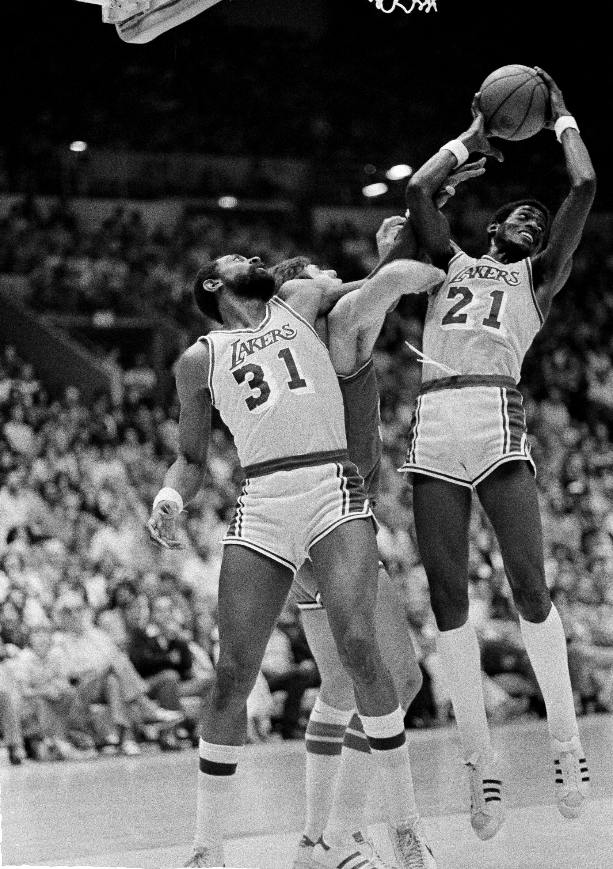 Spencer Haywood of the Lakers restrains Steve Mix of the Philadelphia 76ers in 1980