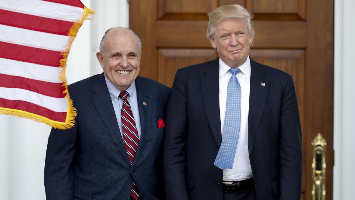 In this Nov. 20, 2016, photo, then-President-elect Trump, right, and former New York Mayor Rudy Giuliani as Giuliani arrives at the Trump National Golf Club Bedminster clubhouse in Bedminster, N.J.
