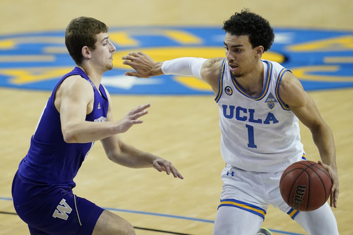 Washington's Erik Stevenson defends UCLA's Jules Bernard.