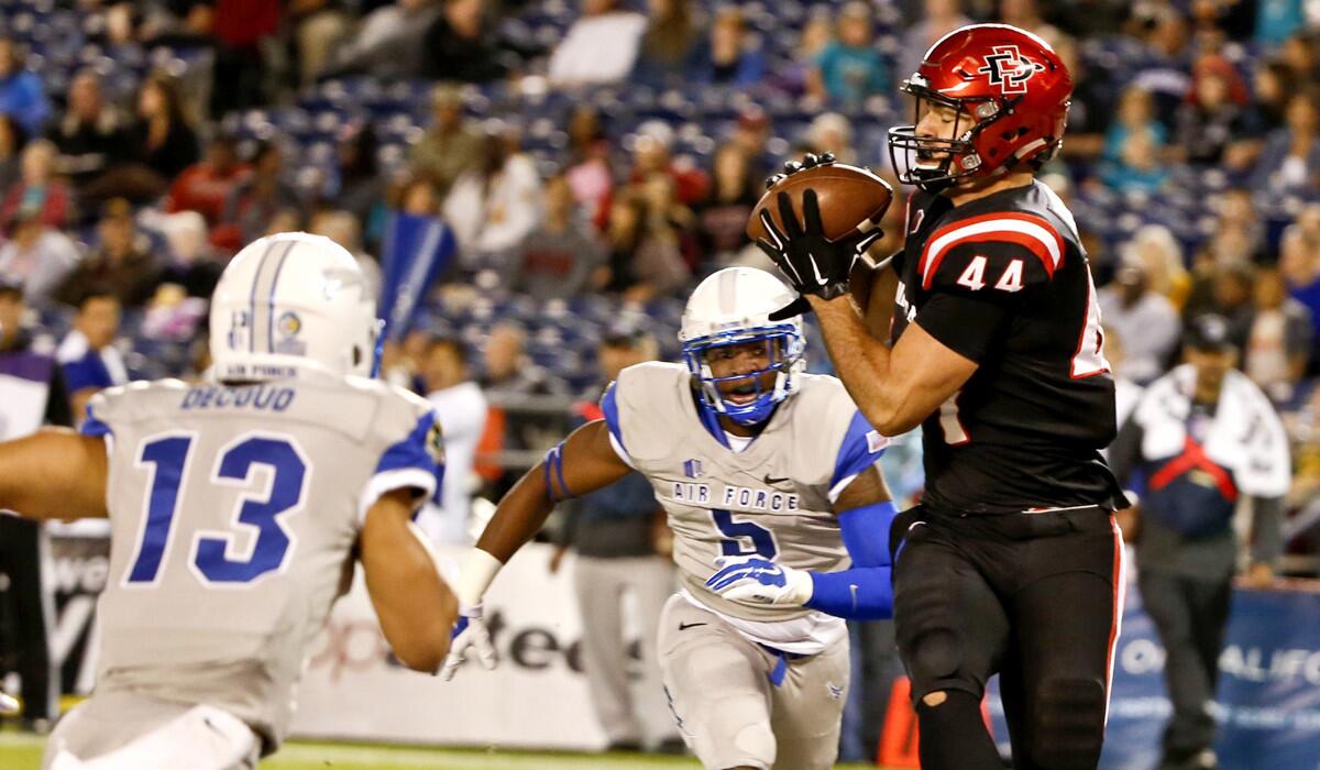 San Diego State fullback Adam Roberts beats two Air Force defenders to make a 14-yard touchdown reception in the first half Friday night.