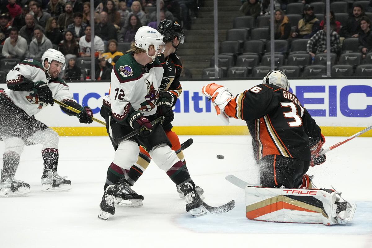 The Coyotes' Nick Ritchie, far left, fires a shot past Ducks goalie John Gibson during the first period Jan. 28, 2023.
