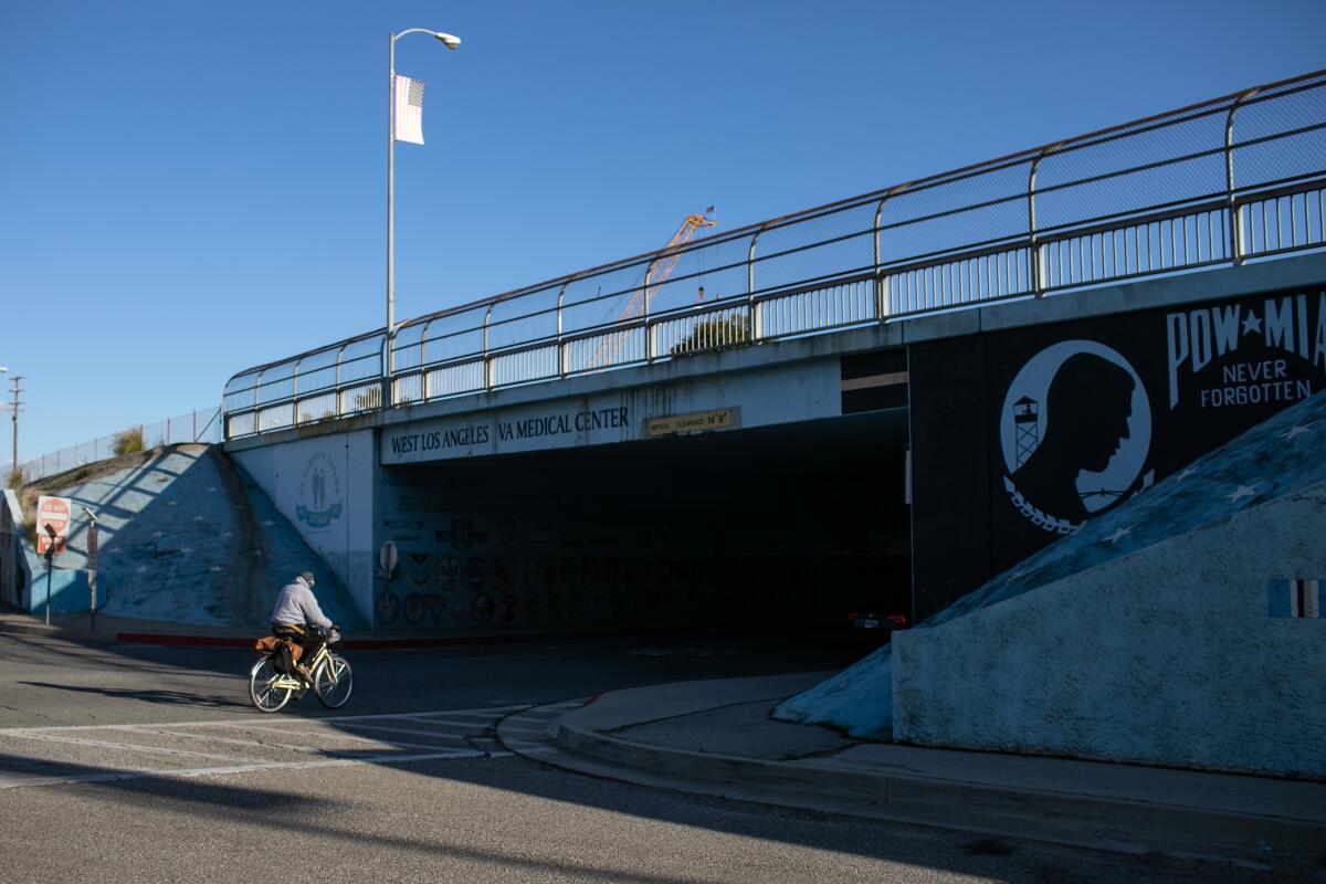 LA cyclist rides near the veterans mural at Wilshire Boulevard and Bonsall Avenue near the VA Hospital in West LA.